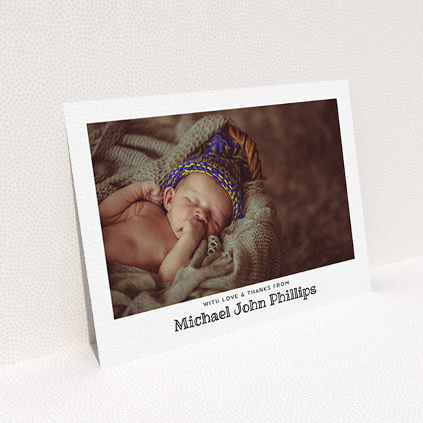 A baptism thank you card named "Simple Photo Frame". It is an A6 card in a landscape orientation. It is a photographic baptism thank you card with room for 1 photo. "Simple Photo Frame" is available as a flat card, with mainly white colouring.