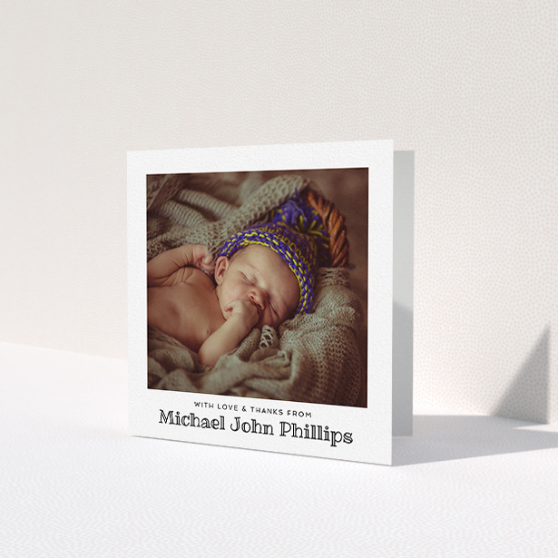 A baptism thank you card template titled 'Simple Photo Frame'. It is a square (148mm x 148mm) card in a square orientation. It is a photographic baptism thank you card with room for 1 photo. 'Simple Photo Frame' is available as a folded card, with mainly white colouring.