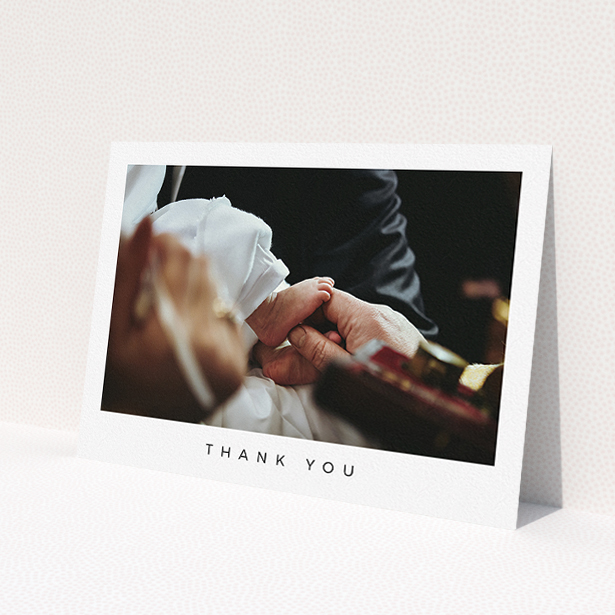 A baptism thank you card named 'Simple Thanks'. It is an A5 card in a landscape orientation. It is a photographic baptism thank you card with room for 1 photo. 'Simple Thanks' is available as a flat card, with mainly white colouring.