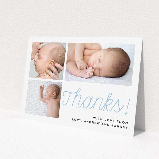 A baptism thank you card design called 'Thank You Cursive'. It is an A5 card in a landscape orientation. It is a photographic baptism thank you card with room for 3 photos. 'Thank You Cursive' is available as a flat card, with tones of white and blue.
