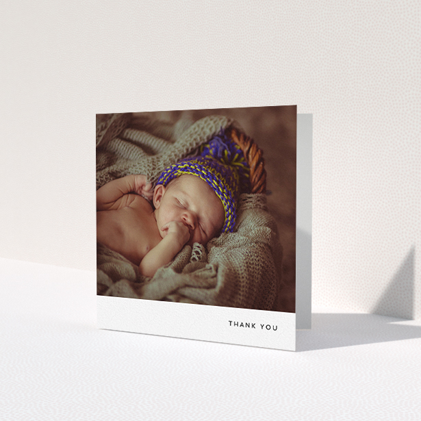 A baptism thank you card called 'Thankful with Simplicity'. It is a square (148mm x 148mm) card in a square orientation. It is a photographic baptism thank you card with room for 1 photo. 'Thankful with Simplicity' is available as a folded card, with mainly white colouring.