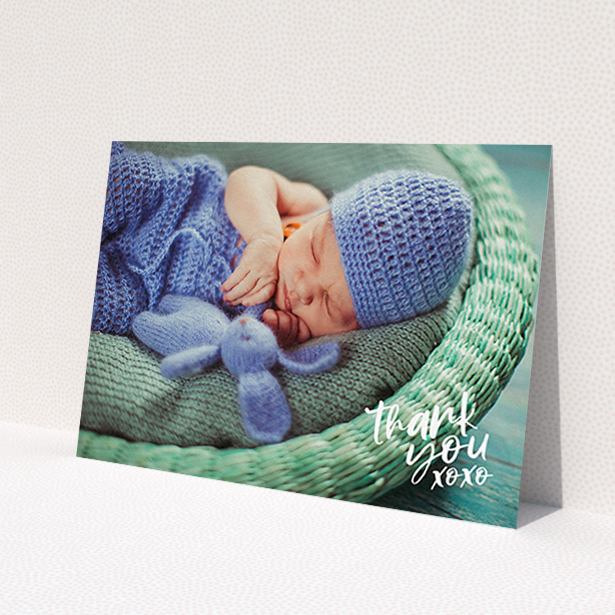 A baptism thank you card design called 'Thanks In the Corner'. It is an A6 card in a landscape orientation. It is a photographic baptism thank you card with room for 1 photo. 'Thanks In the Corner' is available as a flat card, with mainly white colouring.