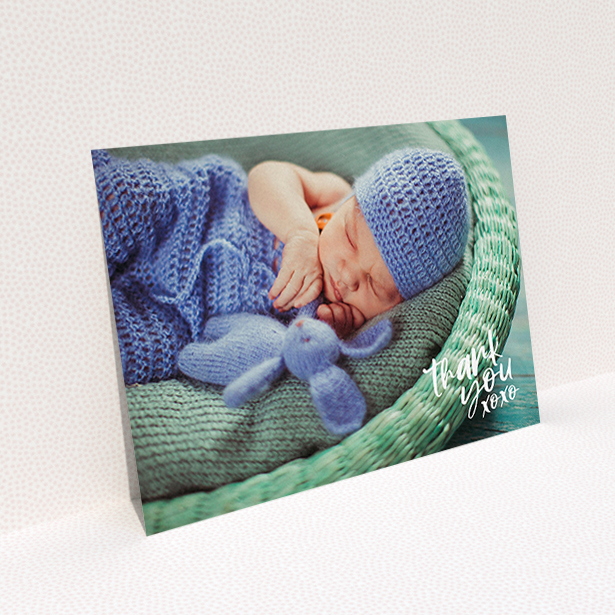 A baptism thank you card design called "Thanks In the Corner". It is an A6 card in a landscape orientation. It is a photographic baptism thank you card with room for 1 photo. "Thanks In the Corner" is available as a flat card, with mainly white colouring.