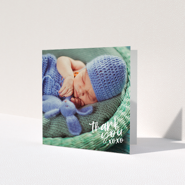 A baptism thank you card named 'Thanks In the Corner'. It is a square (148mm x 148mm) card in a square orientation. It is a photographic baptism thank you card with room for 1 photo. 'Thanks In the Corner' is available as a folded card, with mainly white colouring.