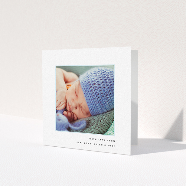 A baptism thank you card called 'Thin Blue Frame'. It is a square (148mm x 148mm) card in a square orientation. It is a photographic baptism thank you card with room for 1 photo. 'Thin Blue Frame' is available as a folded card, with tones of white and blue.