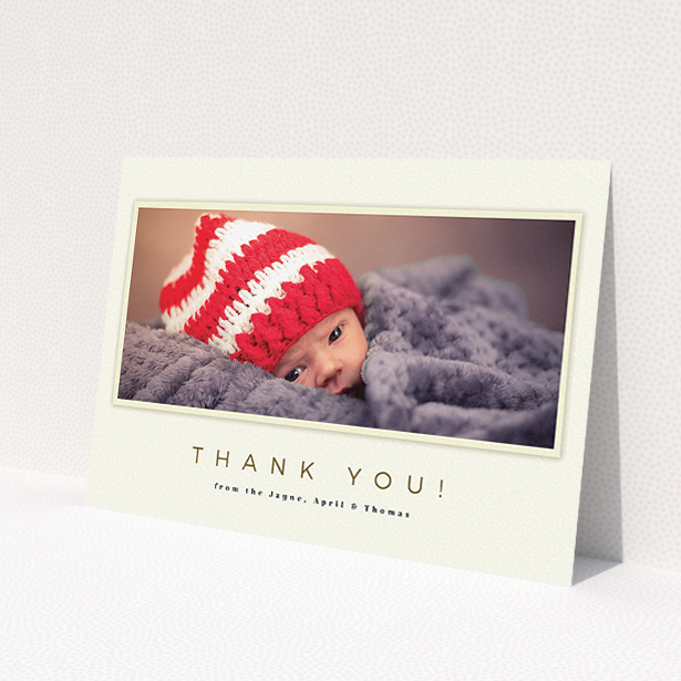 A baptism thank you card called 'Torn Cream Frame'. It is an A5 card in a landscape orientation. It is a photographic baptism thank you card with room for 1 photo. 'Torn Cream Frame' is available as a flat card, with mainly cream colouring.