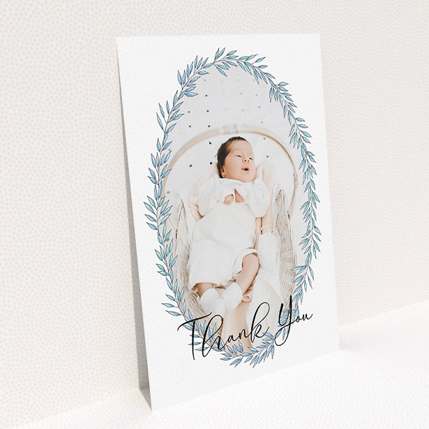 A baptism thank you card design called "Tussled Wreath". It is an A5 card in a portrait orientation. It is a photographic baptism thank you card with room for 1 photo. "Tussled Wreath" is available as a flat card, with tones of blue and white.