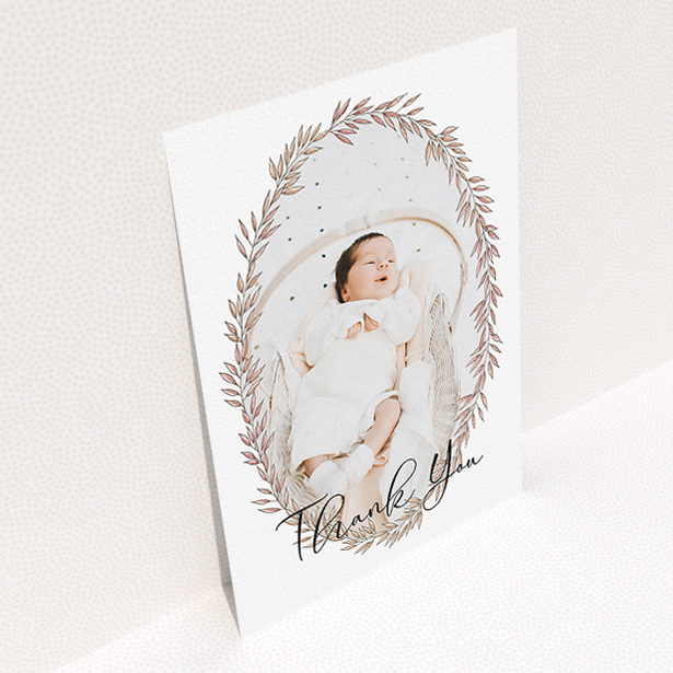 A baptism thank you card design titled "Tussled Wreath". It is an A5 card in a portrait orientation. It is a photographic baptism thank you card with room for 1 photo. "Tussled Wreath" is available as a flat card, with tones of pink and white.