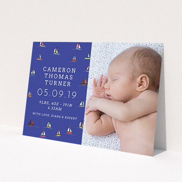 A birth announcement card template titled 'Cowes Week'. It is an A6 card in a landscape orientation. It is a photographic birth announcement card with room for 1 photo. 'Cowes Week' is available as a flat card, with mainly blue colouring.