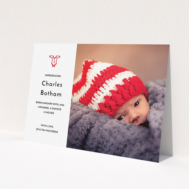 A birth announcement card called 'Onesie'. It is an A5 card in a landscape orientation. It is a photographic birth announcement card with room for 1 photo. 'Onesie' is available as a flat card, with tones of white and red.