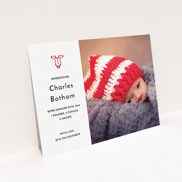 A birth announcement card called "Onesie". It is an A5 card in a landscape orientation. It is a photographic birth announcement card with room for 1 photo. "Onesie" is available as a flat card, with tones of white and red.