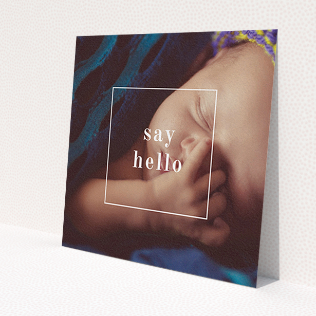 A birth announcement card template titled 'Say Hello'. It is a square (148mm x 148mm) card in a square orientation. It is a photographic birth announcement card with room for 1 photo. 'Say Hello' is available as a flat card, with mainly white colouring.