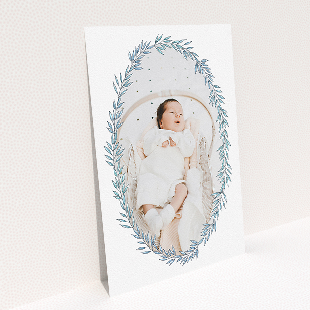 A birth announcement card called "Tussled Wreath". It is an A5 card in a portrait orientation. It is a photographic birth announcement card with room for 1 photo. "Tussled Wreath" is available as a flat card, with tones of blue and white.