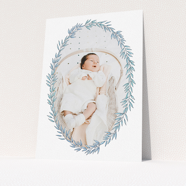 A birth announcement card called "Tussled Wreath". It is an A5 card in a portrait orientation. It is a photographic birth announcement card with room for 1 photo. "Tussled Wreath" is available as a flat card, with tones of blue and white.
