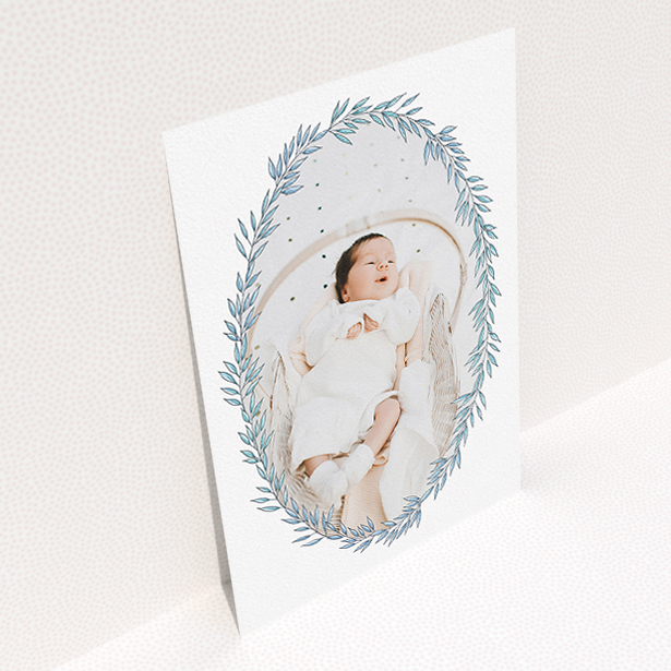 A birth announcement card called "Tussled Wreath". It is an A5 card in a portrait orientation. It is a photographic birth announcement card with room for 1 photo. "Tussled Wreath" is available as a flat card, with tones of blue and white.
