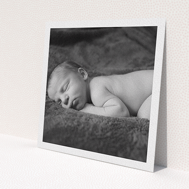 A christening invitation template titled 'Thick White Framed Photo'. It is a square (148mm x 148mm) invite in a square orientation. It is a photographic christening invitation with room for 1 photo. 'Thick White Framed Photo' is available as a flat invite, with mainly white colouring.