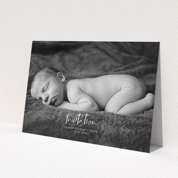 A christening invite design named 'Central Script'. It is an A6 invite in a landscape orientation. It is a photographic christening invite with room for 1 photo. 'Central Script' is available as a flat invite, with mainly white colouring.