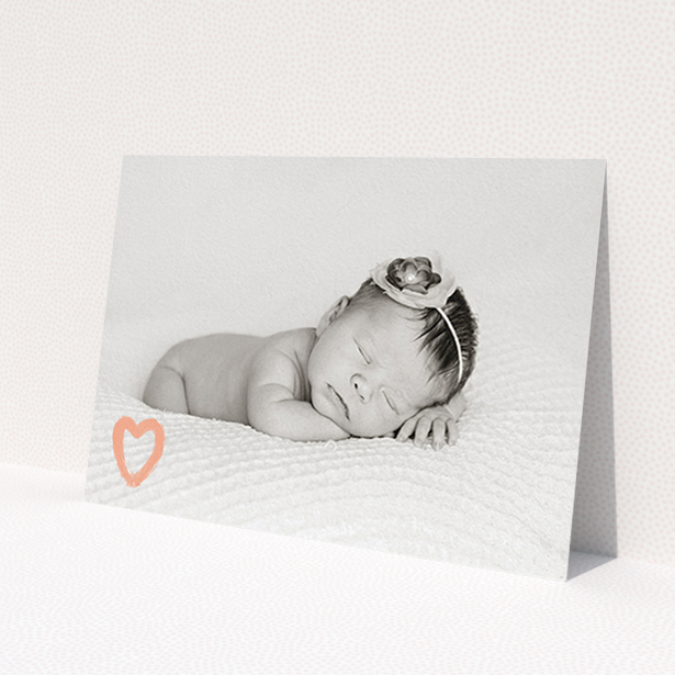 A christening invite called 'Pink heart motif'. It is an A6 invite in a landscape orientation. It is a photographic christening invite with room for 1 photo. 'Pink heart motif' is available as a flat invite, with mainly light pink colouring.