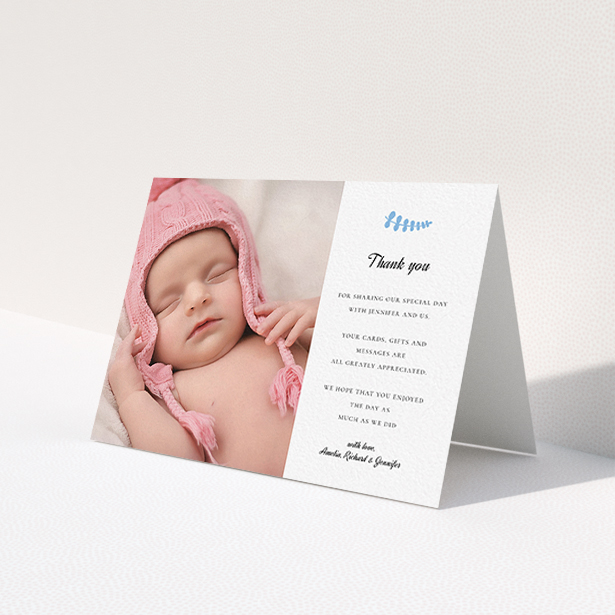A christening thank you card design named 'Blue Fern'. It is an A6 card in a landscape orientation. It is a photographic christening thank you card with room for 1 photo. 'Blue Fern' is available as a folded card, with tones of white and blue.