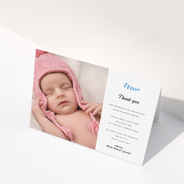 A christening thank you card design named "Blue Fern". It is an A6 card in a landscape orientation. It is a photographic christening thank you card with room for 1 photo. "Blue Fern" is available as a folded card, with tones of white and blue.