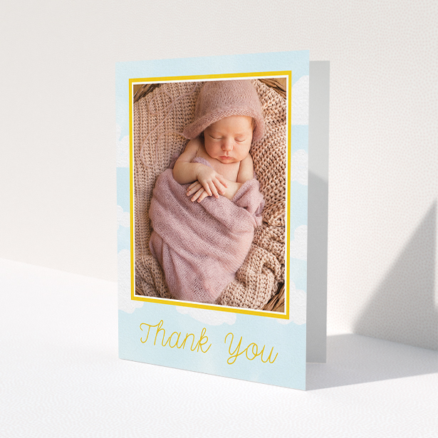 A christening thank you card design named 'Blue Skies'. It is an A5 card in a portrait orientation. It is a photographic christening thank you card with room for 1 photo. 'Blue Skies' is available as a folded card, with tones of blue, yellow and white.