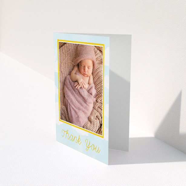 A christening thank you card design named "Blue Skies". It is an A5 card in a portrait orientation. It is a photographic christening thank you card with room for 1 photo. "Blue Skies" is available as a folded card, with tones of blue, yellow and white.