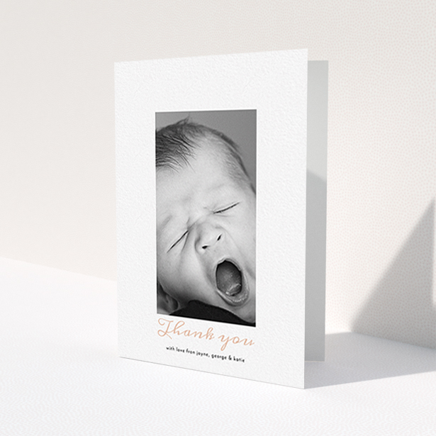 A christening thank you card design called 'Central Portrait'. It is an A6 card in a portrait orientation. It is a photographic christening thank you card with room for 1 photo. 'Central Portrait' is available as a folded card, with tones of white and pink.
