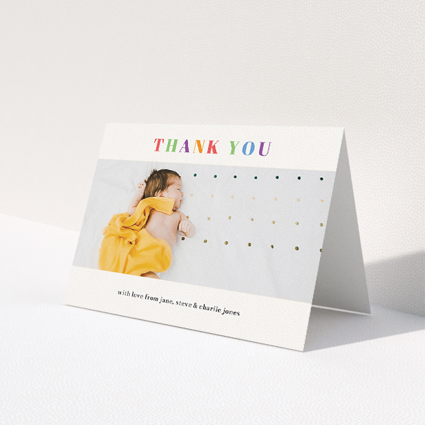 A christening thank you card named 'Colourful Thanks'. It is an A5 card in a landscape orientation. It is a photographic christening thank you card with room for 1 photo. 'Colourful Thanks' is available as a folded card, with tones of white and orange.