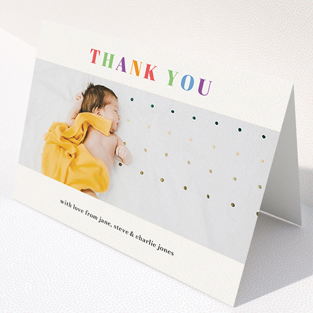 A christening thank you card named "Colourful Thanks". It is an A5 card in a landscape orientation. It is a photographic christening thank you card with room for 1 photo. "Colourful Thanks" is available as a folded card, with tones of white and orange.