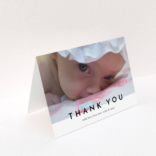 A christening thank you card named "Cross Border". It is an A5 card in a landscape orientation. It is a photographic christening thank you card with room for 1 photo. "Cross Border" is available as a folded card, with mainly white colouring.