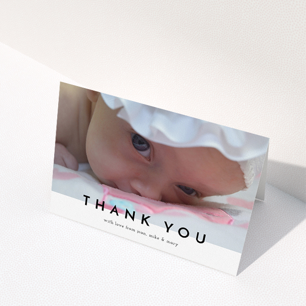 A christening thank you card named "Cross Border". It is an A5 card in a landscape orientation. It is a photographic christening thank you card with room for 1 photo. "Cross Border" is available as a folded card, with mainly white colouring.