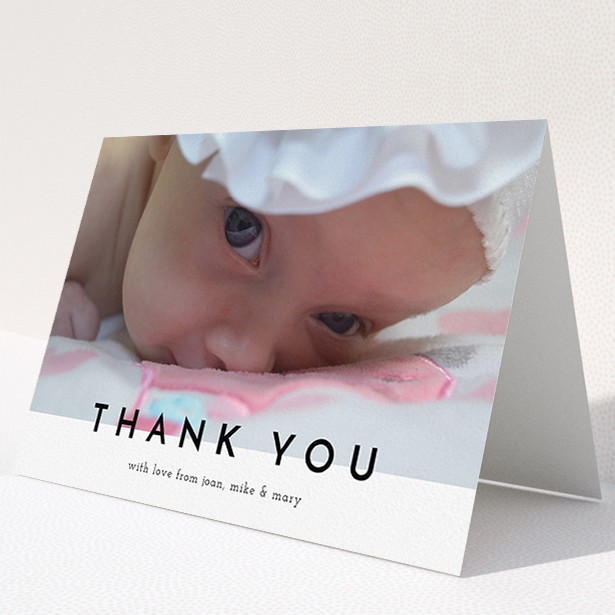 A christening thank you card named "Cross Border". It is an A5 card in a landscape orientation. It is a photographic christening thank you card with room for 1 photo. "Cross Border" is available as a folded card, with mainly white colouring.