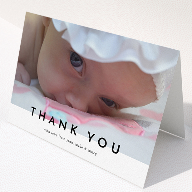 A christening thank you card named "Cross Border". It is an A5 card in a landscape orientation. It is a photographic christening thank you card with room for 1 photo. "Cross Border" is available as a folded card, with mainly white colouring.