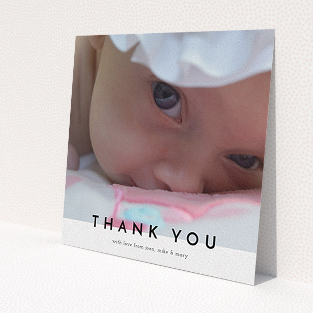 A christening thank you card design titled 'Cross Border'. It is a square (148mm x 148mm) card in a square orientation. It is a photographic christening thank you card with room for 1 photo. 'Cross Border' is available as a flat card, with mainly white colouring.
