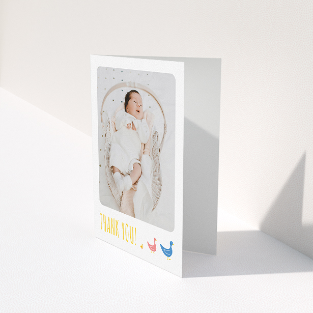 A christening thank you card named "Family of Ducks". It is an A5 card in a portrait orientation. It is a photographic christening thank you card with room for 1 photo. "Family of Ducks" is available as a folded card, with tones of yellow, blue and pink.