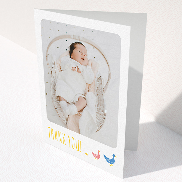 A christening thank you card named "Family of Ducks". It is an A5 card in a portrait orientation. It is a photographic christening thank you card with room for 1 photo. "Family of Ducks" is available as a folded card, with tones of yellow, blue and pink.