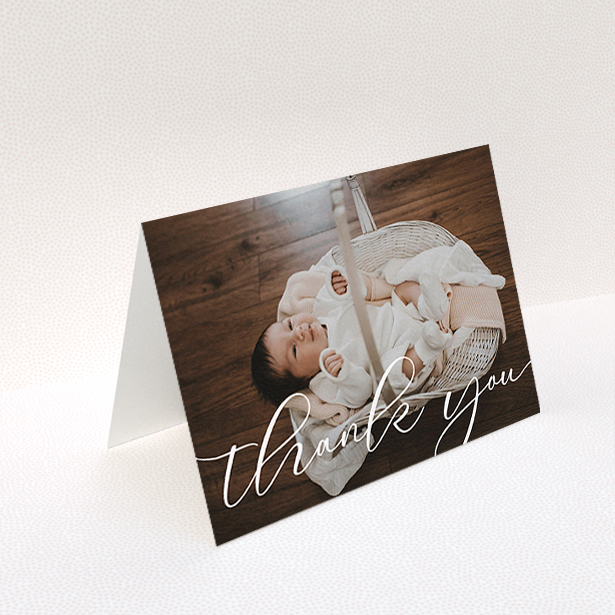 A christening thank you card design titled "One Photo". It is an A6 card in a landscape orientation. It is a photographic christening thank you card with room for 1 photo. "One Photo" is available as a folded card, with mainly white colouring.