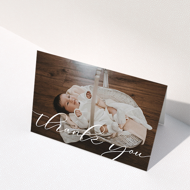 A christening thank you card design titled "One Photo". It is an A6 card in a landscape orientation. It is a photographic christening thank you card with room for 1 photo. "One Photo" is available as a folded card, with mainly white colouring.