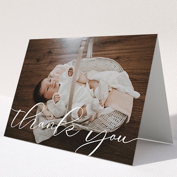 A christening thank you card design titled "One Photo". It is an A6 card in a landscape orientation. It is a photographic christening thank you card with room for 1 photo. "One Photo" is available as a folded card, with mainly white colouring.