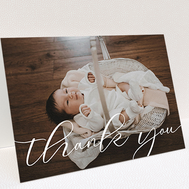 A christening thank you card design titled "One Photo". It is an A6 card in a landscape orientation. It is a photographic christening thank you card with room for 1 photo. "One Photo" is available as a folded card, with mainly white colouring.