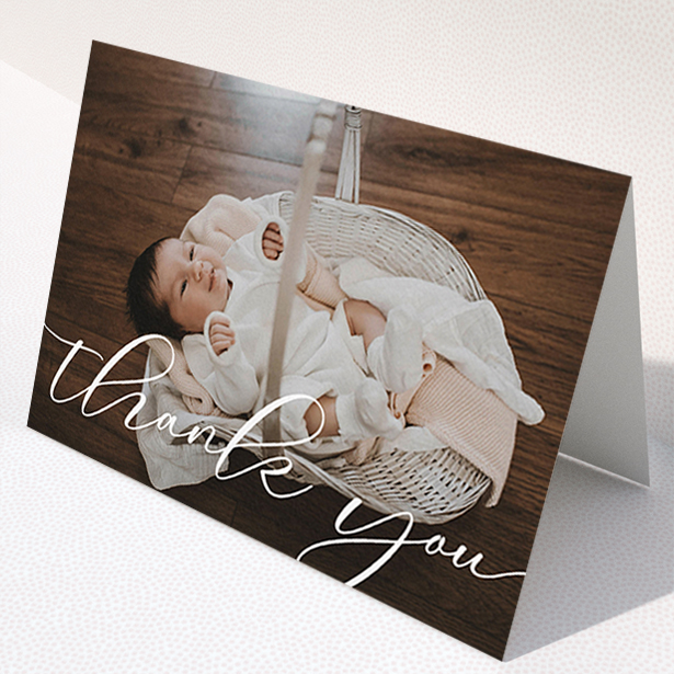 A christening thank you card design titled "One Photo". It is an A6 card in a landscape orientation. It is a photographic christening thank you card with room for 1 photo. "One Photo" is available as a folded card, with mainly white colouring.