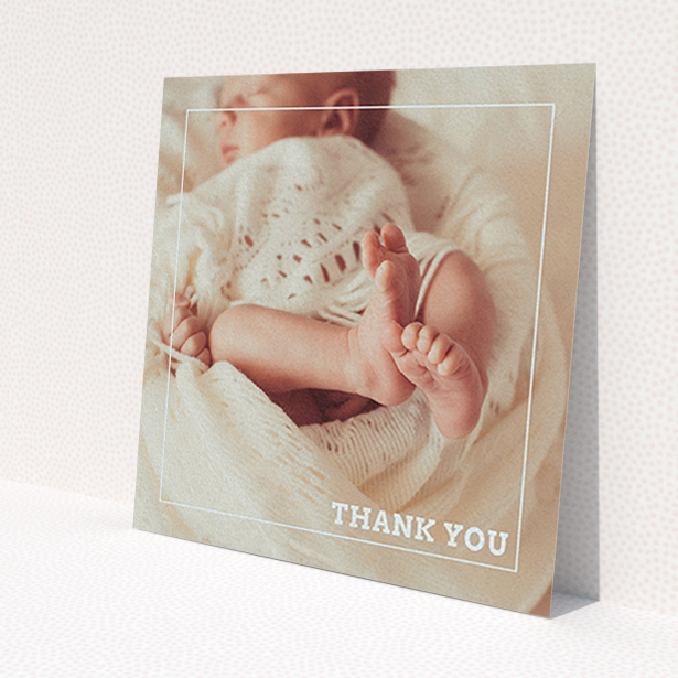 A christening thank you card template titled 'Over Photo Frame'. It is a square (148mm x 148mm) card in a square orientation. It is a photographic christening thank you card with room for 1 photo. 'Over Photo Frame' is available as a flat card, with mainly pale pink colouring.