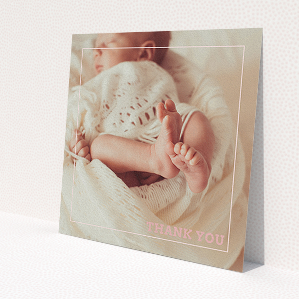 A christening thank you card design named 'Over Photo Frame'. It is a square (148mm x 148mm) card in a square orientation. It is a photographic christening thank you card with room for 1 photo. 'Over Photo Frame' is available as a flat card, with mainly light pink colouring.