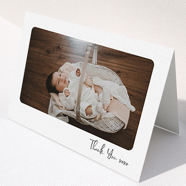 A christening thank you card design named "Rounded Thanks". It is an A6 card in a landscape orientation. It is a photographic christening thank you card with room for 1 photo. "Rounded Thanks" is available as a folded card, with mainly white colouring.