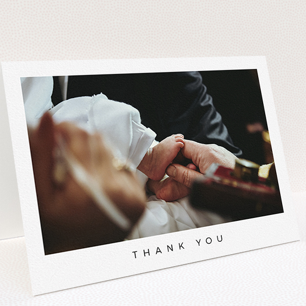 A christening thank you card design named "Simple Thanks". It is an A5 card in a landscape orientation. It is a photographic christening thank you card with room for 1 photo. "Simple Thanks" is available as a folded card, with mainly white colouring.