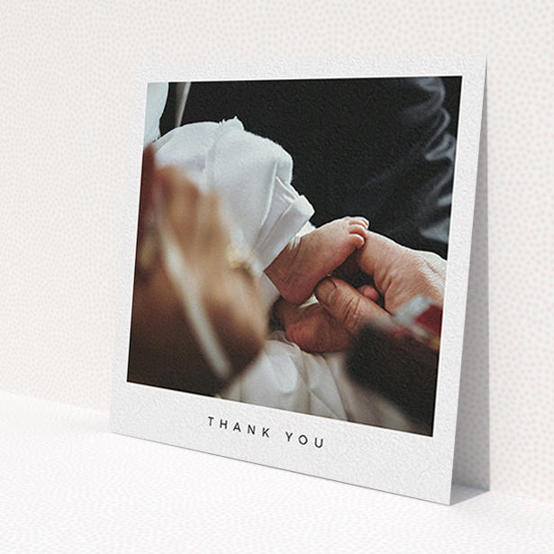 A christening thank you card template titled 'Simple Thanks'. It is a square (148mm x 148mm) card in a square orientation. It is a photographic christening thank you card with room for 1 photo. 'Simple Thanks' is available as a flat card, with mainly white colouring.