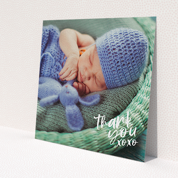 A christening thank you card template titled 'Thanks In the Corner'. It is a square (148mm x 148mm) card in a square orientation. It is a photographic christening thank you card with room for 1 photo. 'Thanks In the Corner' is available as a flat card, with mainly white colouring.