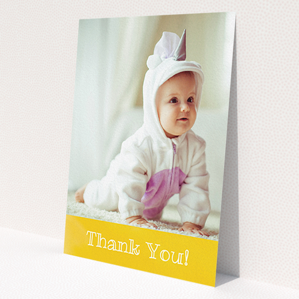 A christening thank you card template titled 'Thanks In Yellow'. It is an A6 card in a portrait orientation. It is a photographic christening thank you card with room for 1 photo. 'Thanks In Yellow' is available as a flat card, with tones of yellow and white.