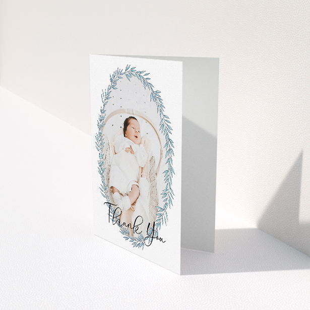 A christening thank you card design called "Tussled Wreath". It is an A5 card in a portrait orientation. It is a photographic christening thank you card with room for 1 photo. "Tussled Wreath" is available as a folded card, with tones of blue and white.