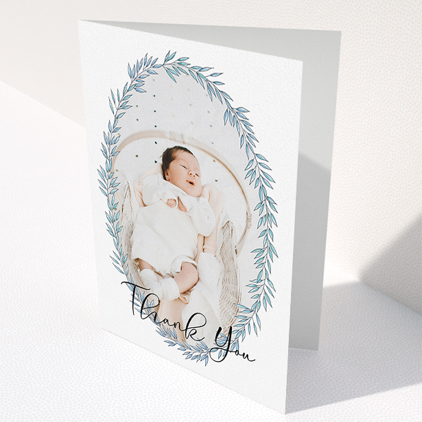 A christening thank you card design called "Tussled Wreath". It is an A5 card in a portrait orientation. It is a photographic christening thank you card with room for 1 photo. "Tussled Wreath" is available as a folded card, with tones of blue and white.